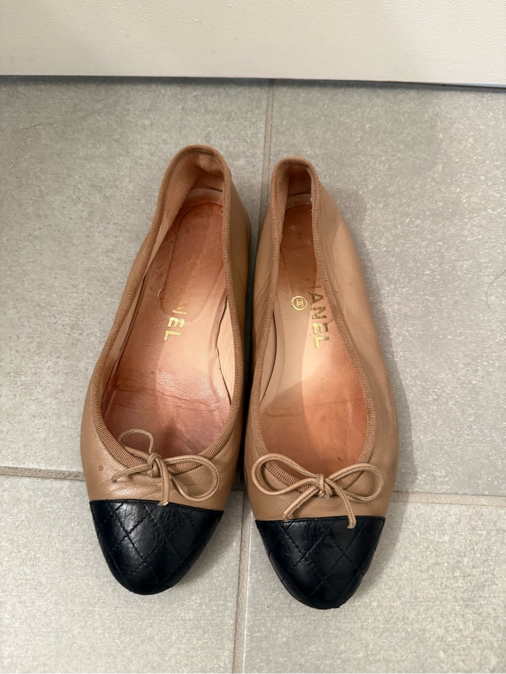 CHANEL Two-Tone Quilted Cap-Toe Ballet Flats in Tan and Black